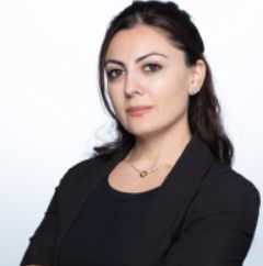 Image showing Anush Gasparian of Phonexa, wearing a black dress, looking towards the camera.