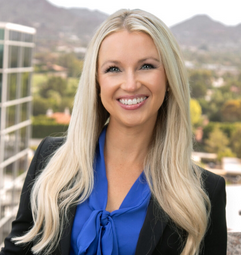 Image showing Haley Harrigan of Gallagher & Kennedy, with long blond hair, wearing a formal blue shirt, smiling towards the camera.